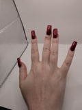 #59 Base Coat: Red shimmer base coat with black opalescent gem on ring fingers and gold moon and star motiff on the thumbs featured on medium square nails