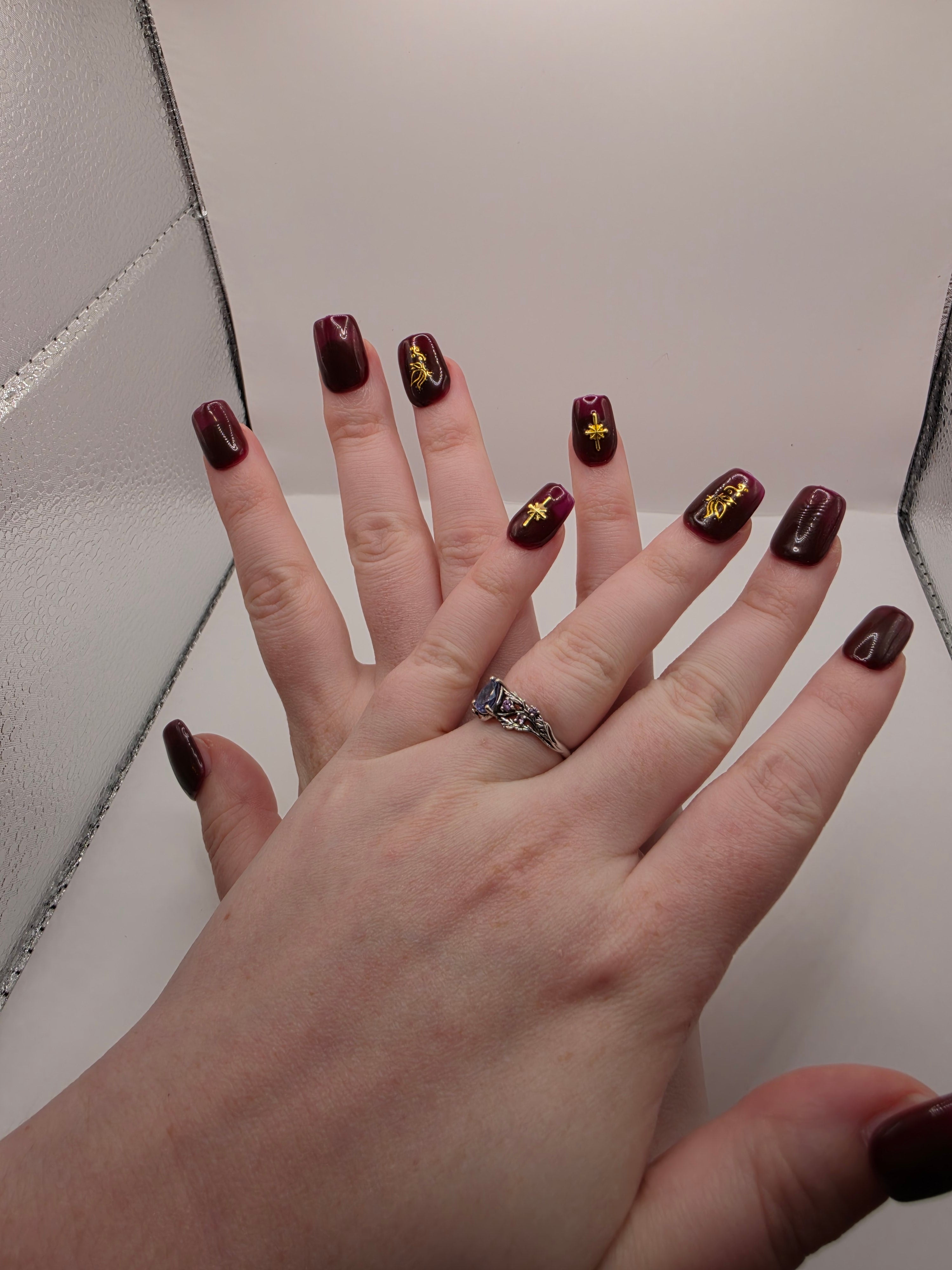 #158 Base Coat: A deliscous dark berry shade with brown undertones decorated with a butterfly design on the ring fingers and an elongated eight-pointed star charm inbedded into the pinky nails designed on short square nails