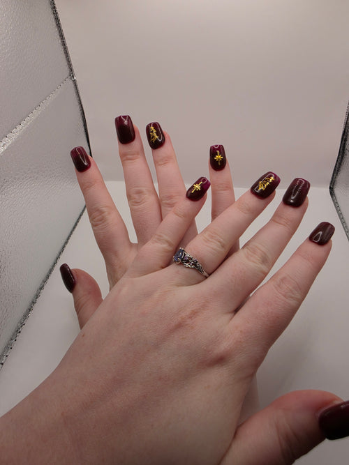 #158 Base Coat: A deliscous dark berry shade with brown undertones decorated with a butterfly design on the ring fingers and an elongated eight-pointed star charm inbedded into the pinky nails designed on short square nails