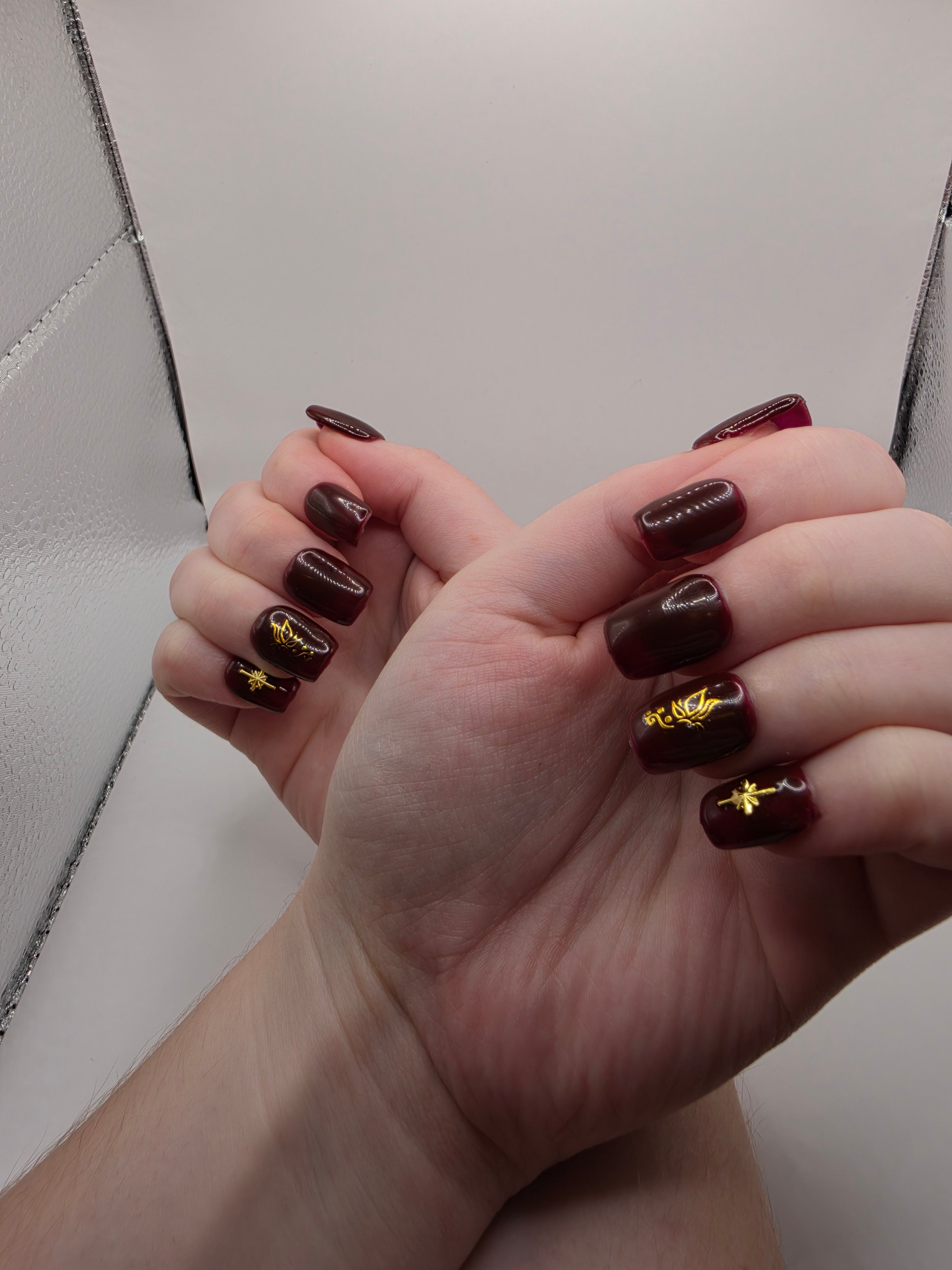 #158 Base Coat: A deliscous dark berry shade with brown undertones decorated with a butterfly design on the ring fingers and an elongated eight-pointed star charm inbedded into the pinky nails designed on short square nails