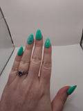 #147 Base Coat: A summery sensational turquoise with three different colored flower charms (purple, light blue, and hot pink) inbedded into the accent ring finger nail featured on short almond nails